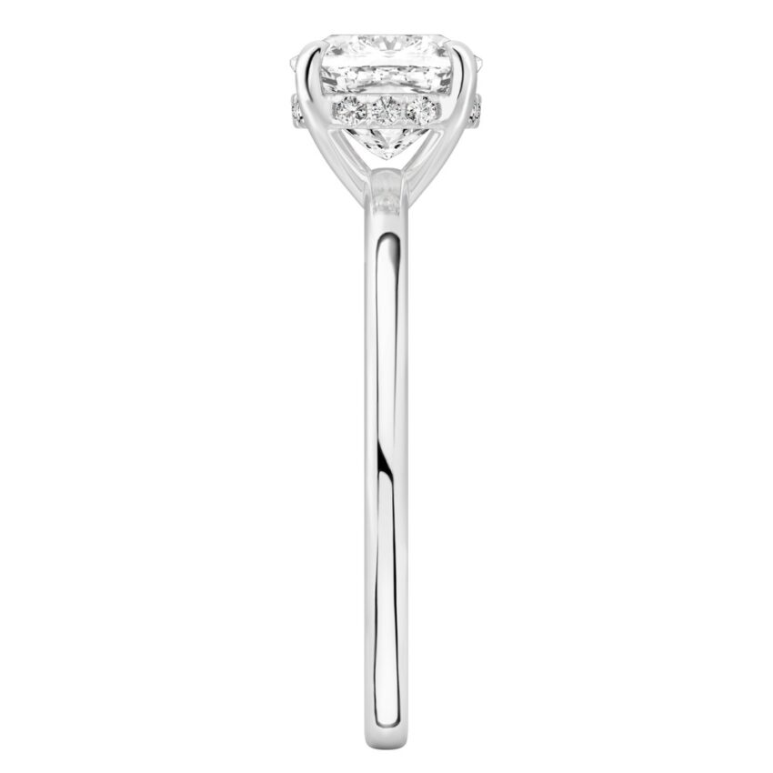 Side view of cushion cut diamond ultra low hidden halo engagement ring in white gold