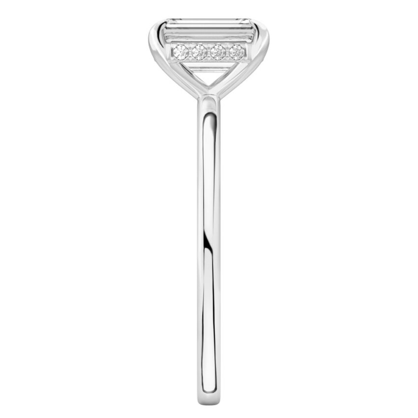 Side view of emerald cut diamond hidden halo engagement ring in platinum