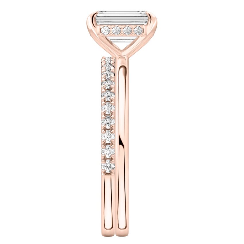 Side view of emerald cut diamond hidden halo engagement ring set rose gold