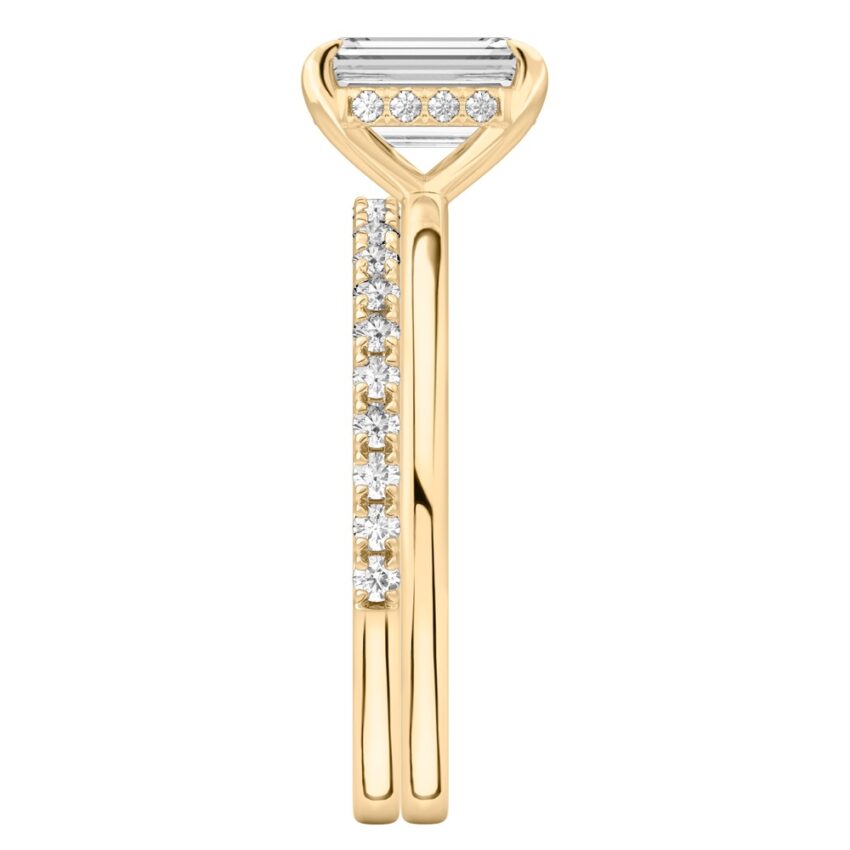 Side view of emerald cut diamond hidden halo engagement ring set yellow gold