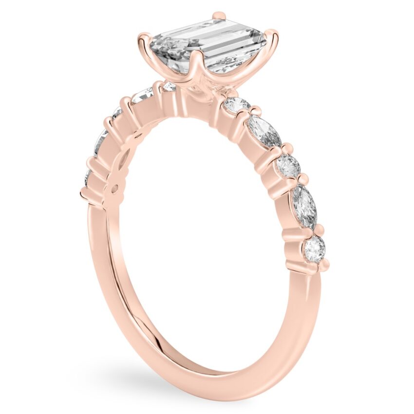 Angle view of emerald cut diamond marquise and round diamond ring rose gold