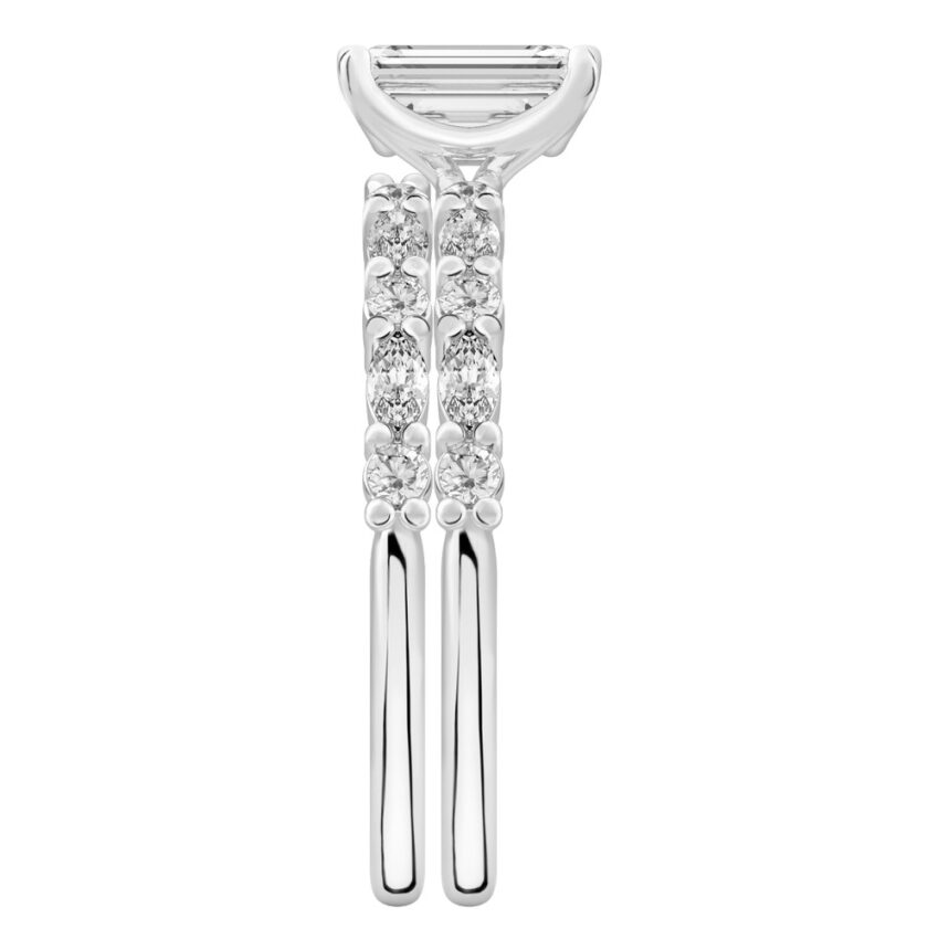 Side view of emerald cut diamond marquise and round diamond ring set white gold
