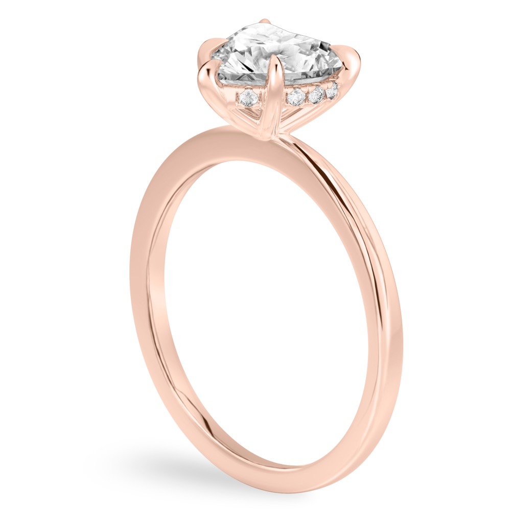 Angle view of heart shape diamond hidden halo engagement ring in rose gold
