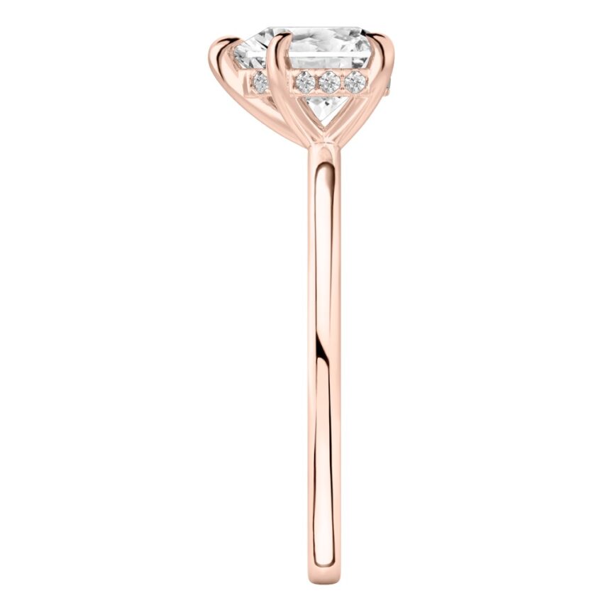 Side view of heart shape diamond hidden halo engagement ring in rose gold