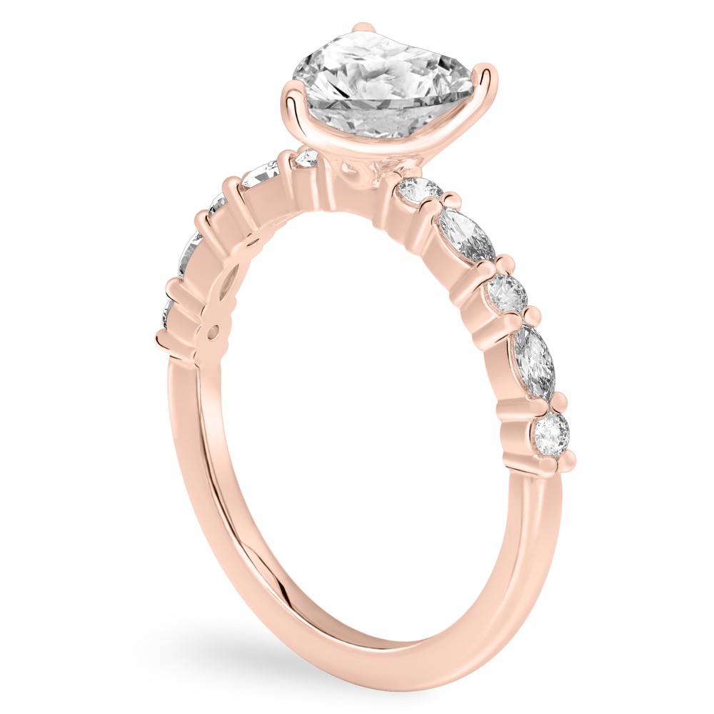 Angle view of heart shape diamond marquise and round diamond ring rose gold