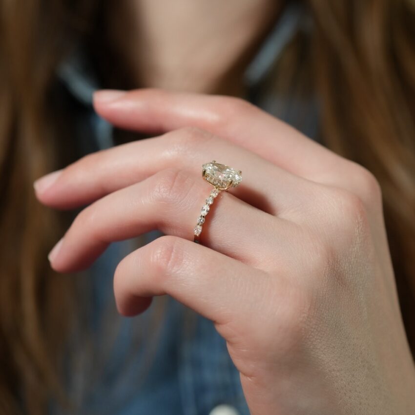 Angle view of hidden halo marquise and round diamond ring lifestyle
