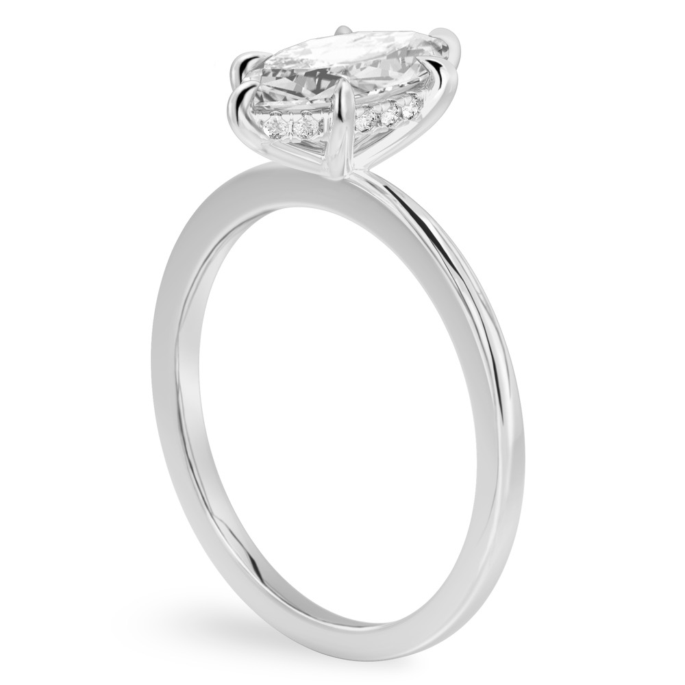 Angle view of marquise cut diamond flush hidden halo engagement ring in platinum