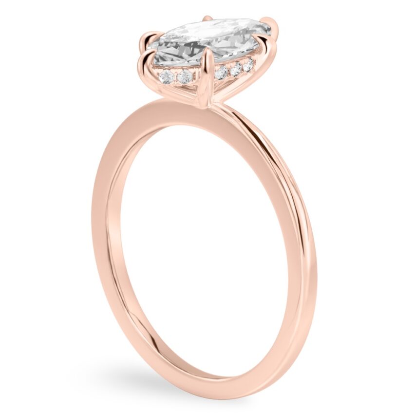 Angle view of marquise cut diamond hidden halo engagement ring in rose gold