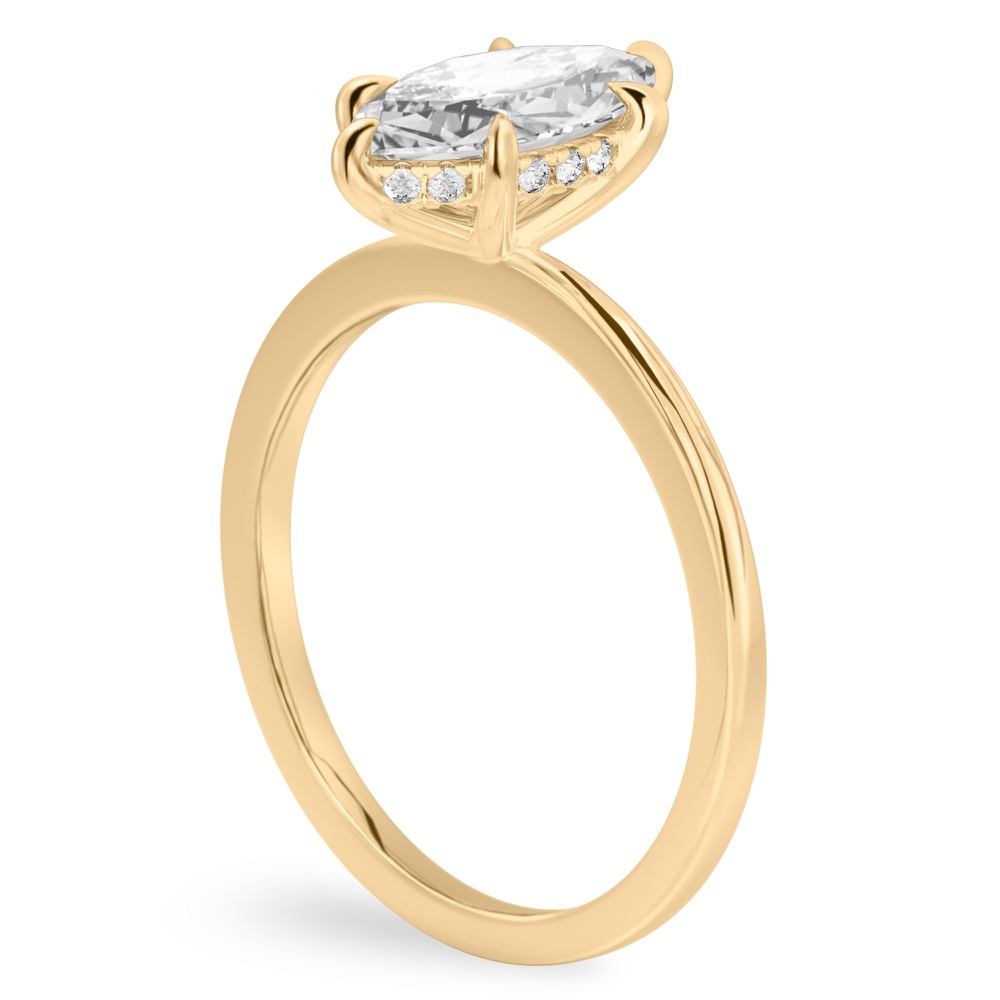 Angle view of marquise cut diamond hidden halo engagement ring in yellow gold