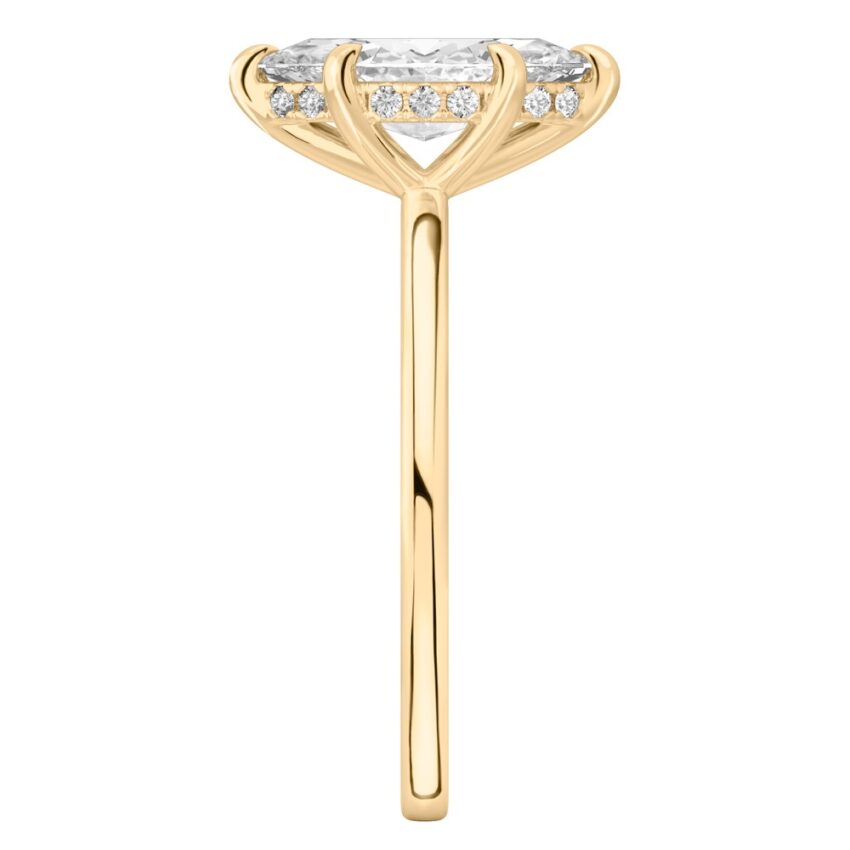 Side view of marquise cut diamond hidden halo engagement ring in yellow gold