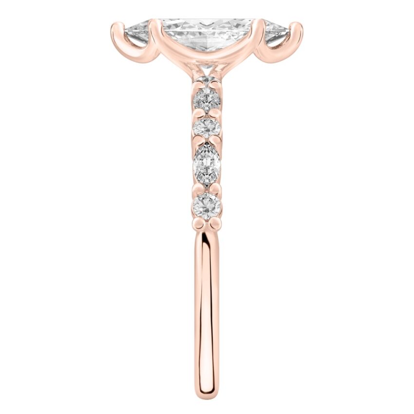 Side view of marquise cut diamond marquise and round diamond ring rose gold
