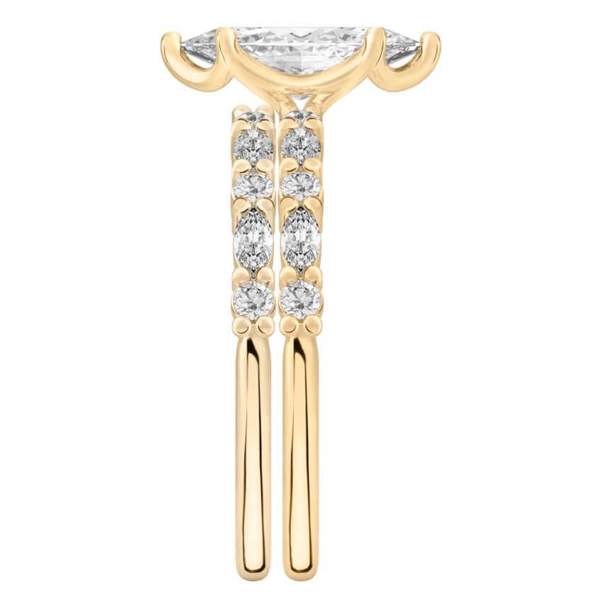 Side view of marquise cut diamond marquise and round diamond ring set yellow gold