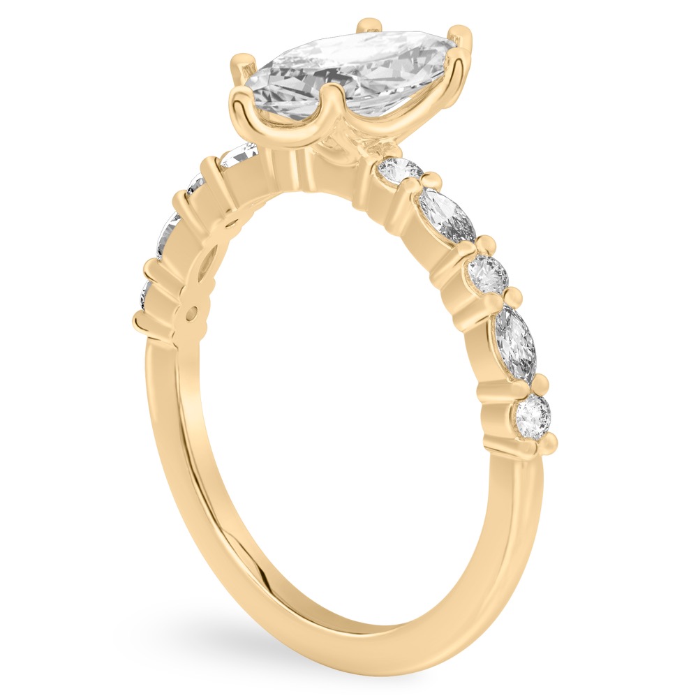 Angle view of marquise cut diamond marquise and round diamond ring yellow gold