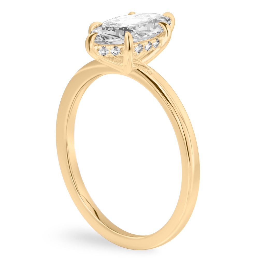 Angle view of marquise cut diamond ultra low hidden halo engagement ring in yellow gold