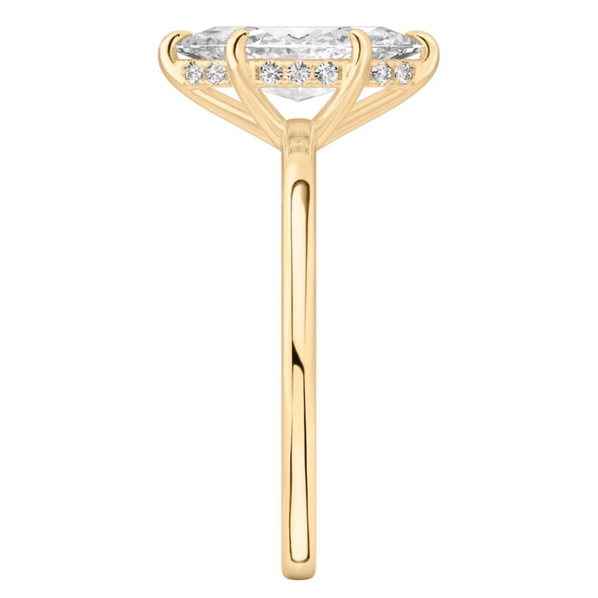 Side view of marquise cut diamond ultra low hidden halo engagement ring in yellow gold