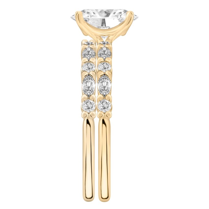 Side view of oval cut diamond marquise and round diamond ring set yellow gold