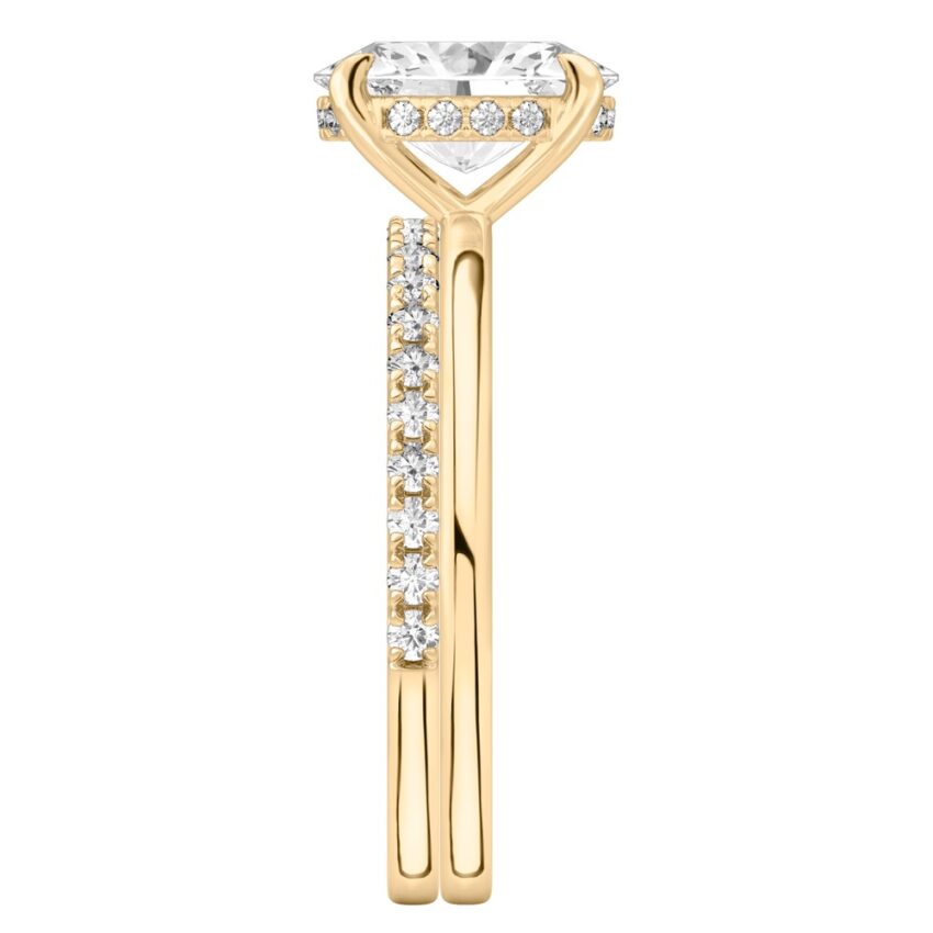 Side view of oval shape diamond hidden halo engagement ring set yellow gold