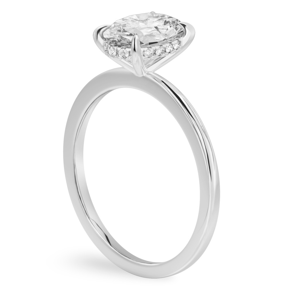 Angle view of oval shape diamond hidden halo engagement ring in white gold