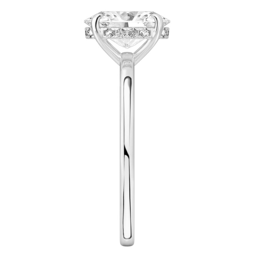 Side view of oval shape diamond ultra low hidden halo engagement ring in platinum