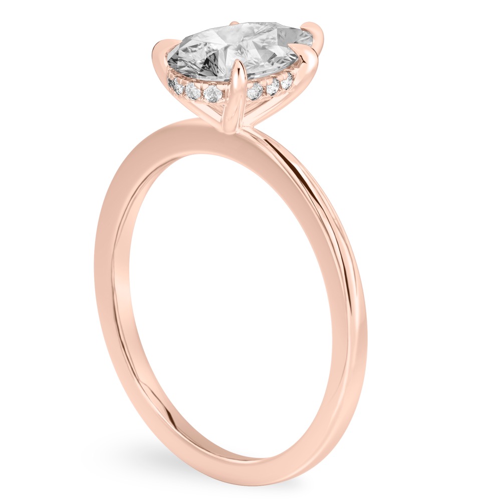 Angle view of pear shape diamond hidden halo engagement ring in rose gold