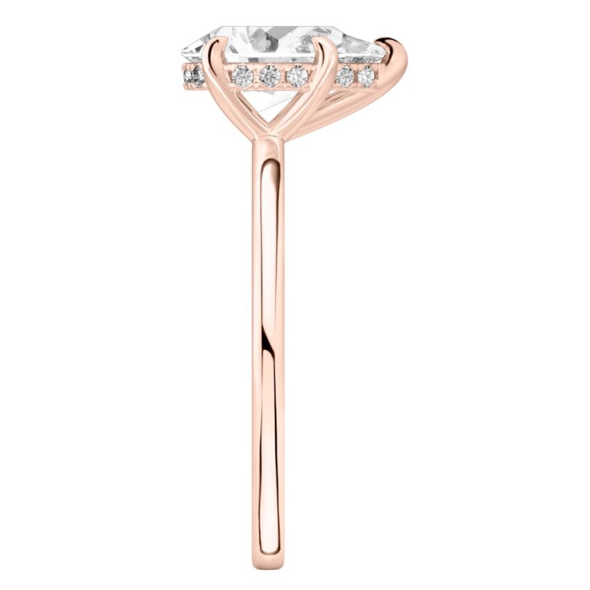 Side view of pear shape diamond hidden halo engagement ring in rose gold