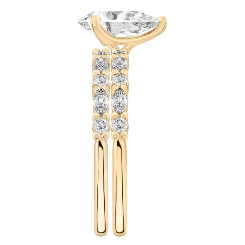 Side view of pear shape diamond marquise and round diamond ring set yellow gold