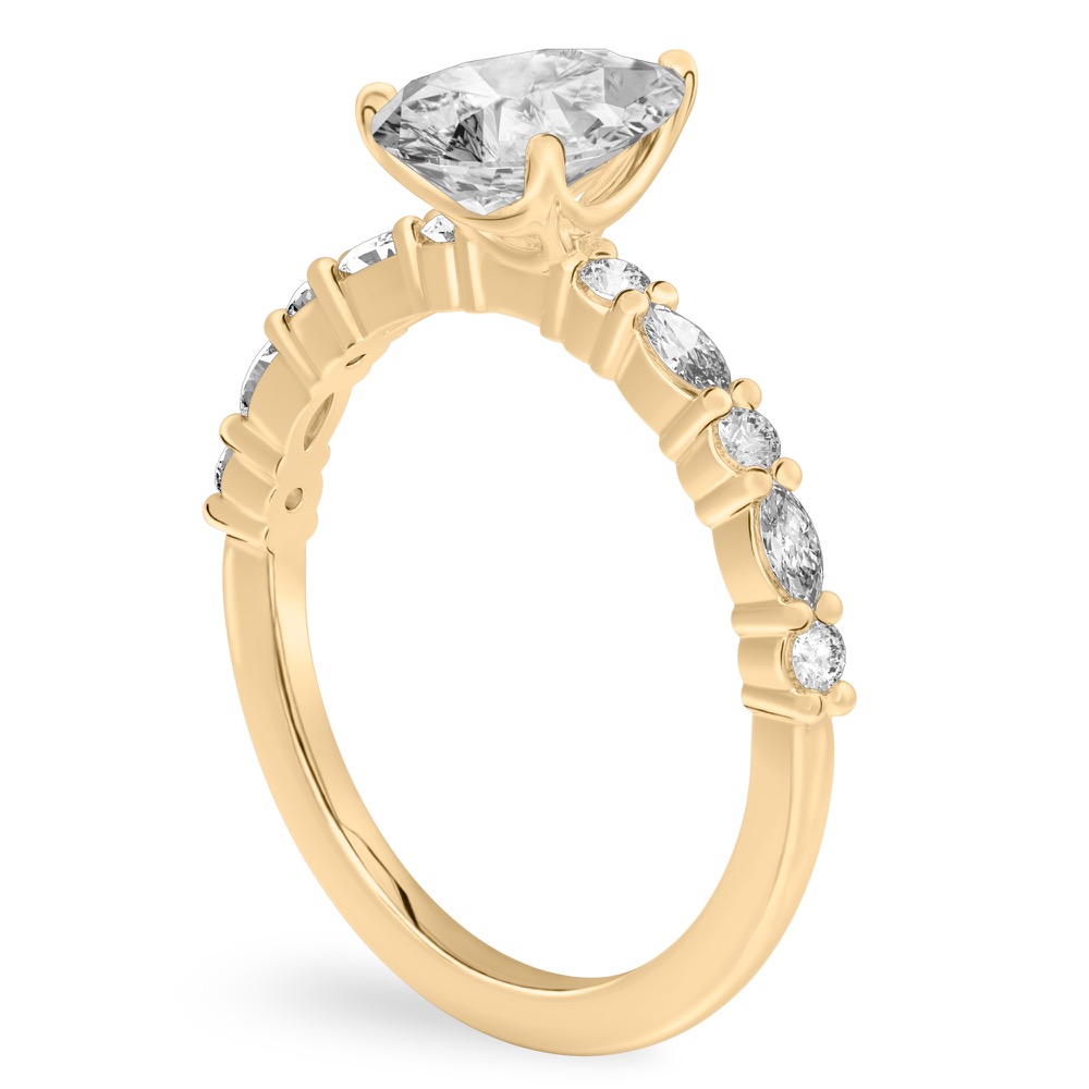Angle view of pear shape diamond marquise and round diamond ring yellow gold