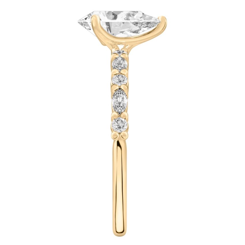 Side view of pear shape diamond marquise and round diamond ring yellow gold