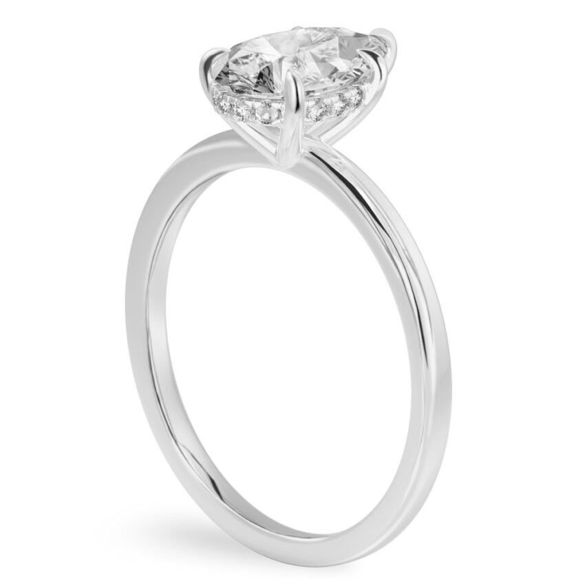 Angle view of pear shape diamond ultra low hidden halo engagement ring in palladium
