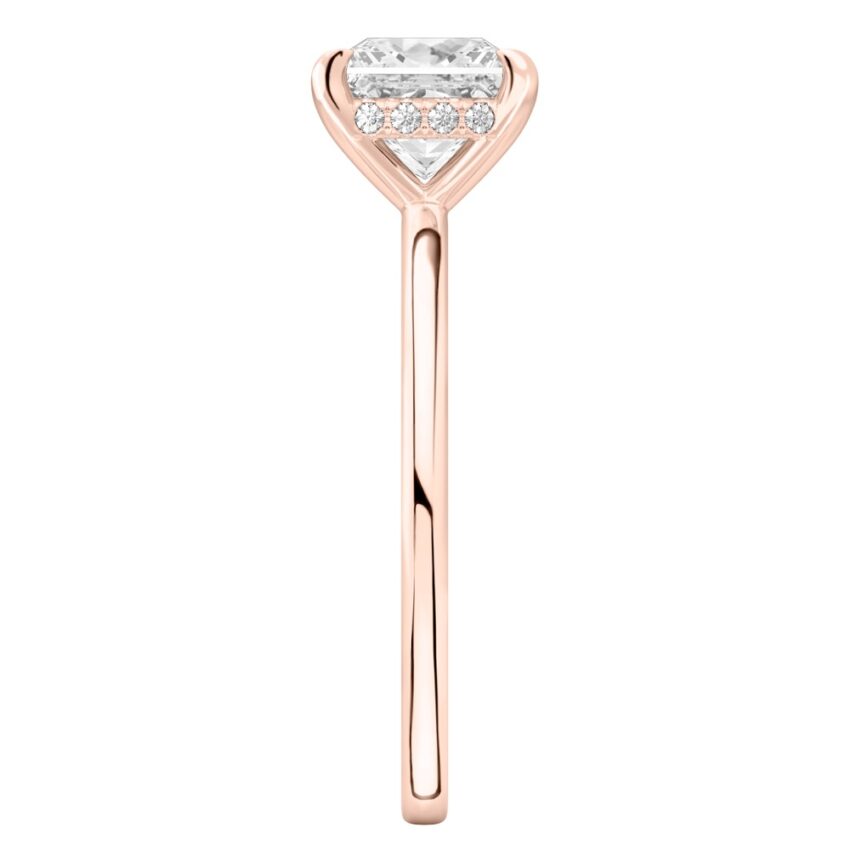 Side view of princess cut diamond hidden halo engagement ring in rose gold
