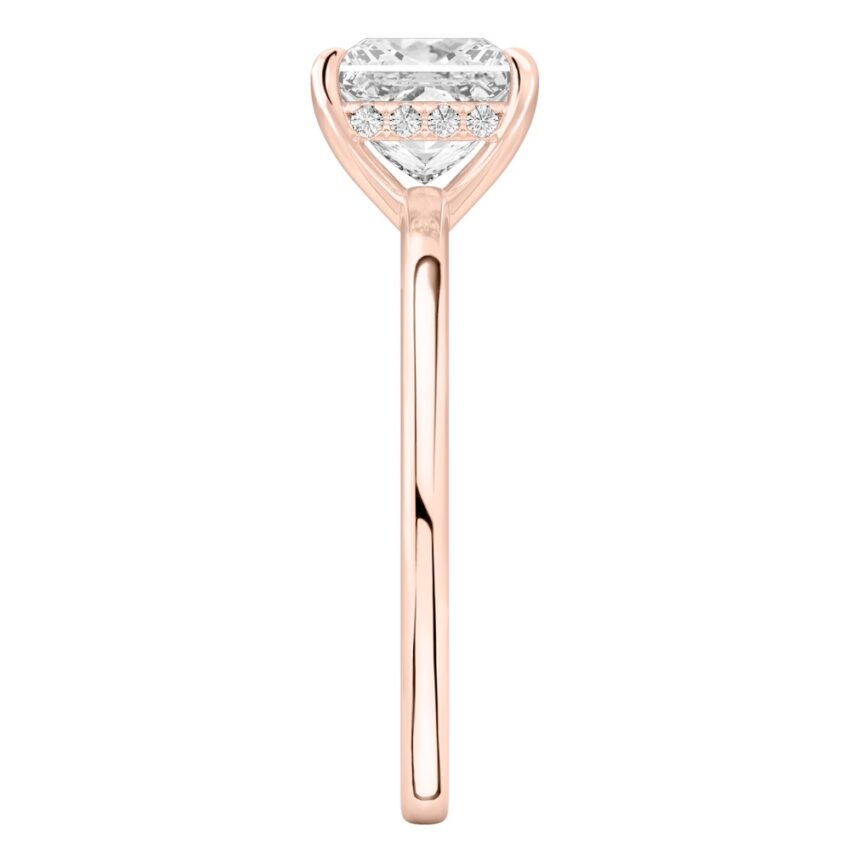 Side view of princess cut diamond ultra low hidden halo engagement ring in rose gold