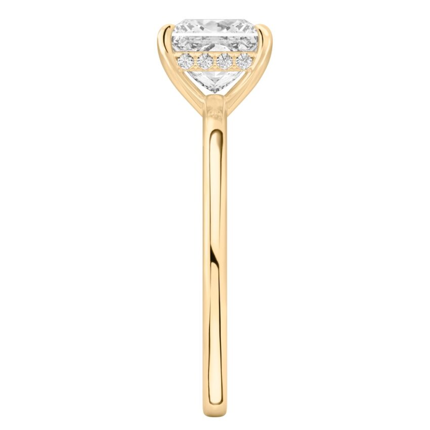Side view of princess cut diamond ultra low hidden halo engagement ring in yellow gold