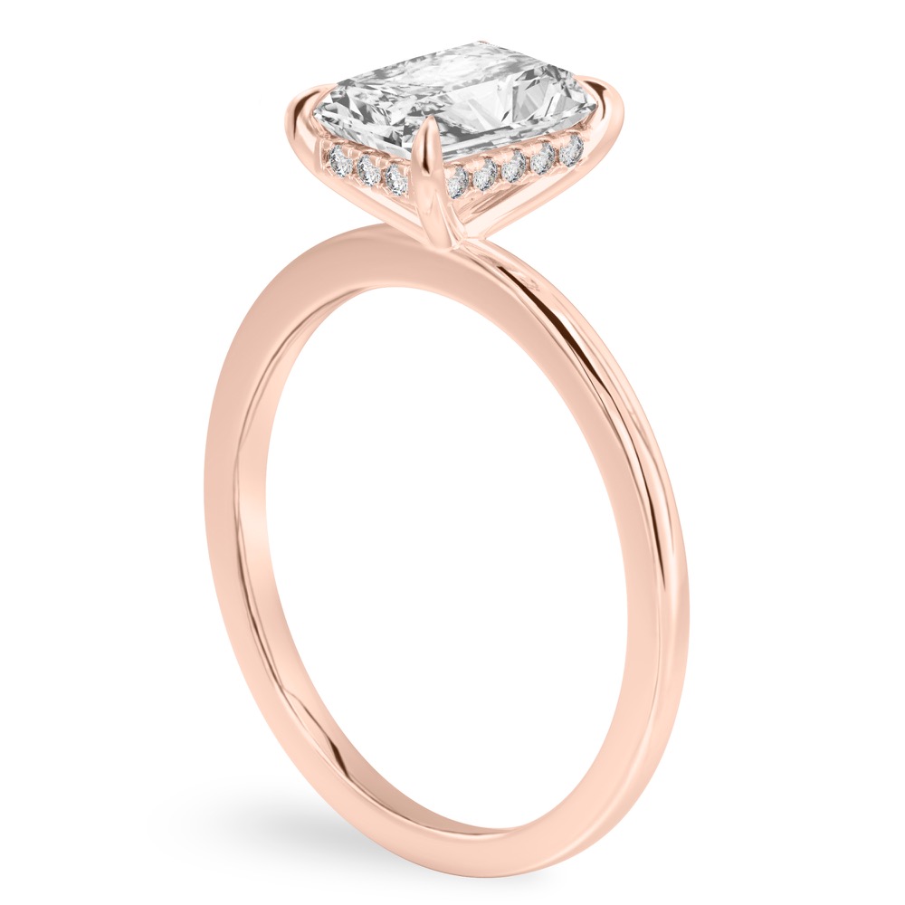 Angle view of radiant cut diamond hidden halo engagement ring in rose gold