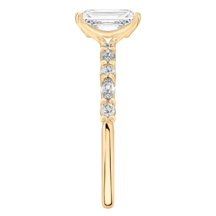 Side view of radiant cut diamond marquise and round diamond ring yellow gold