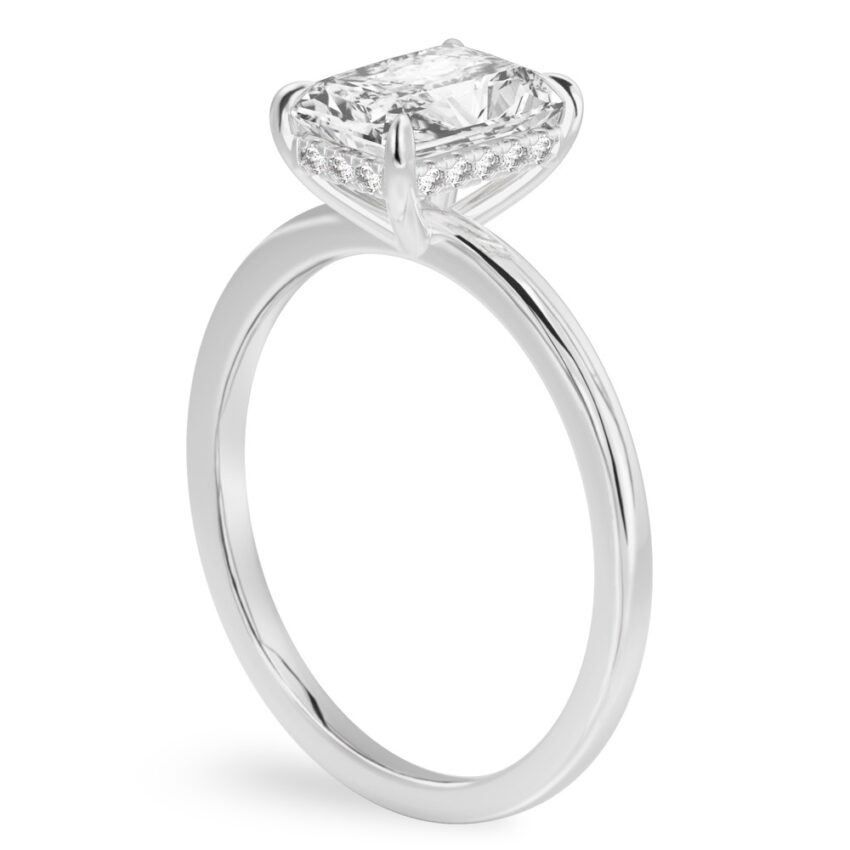 Angle view of radiant cut diamond ultra low hidden halo engagement ring in platinum
