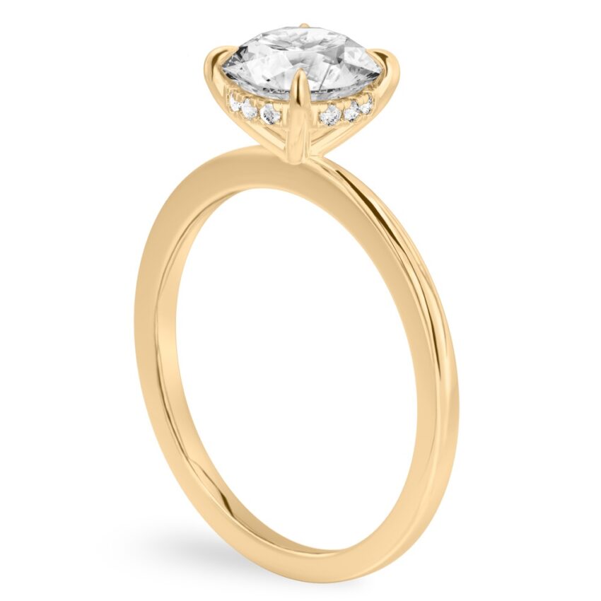 Angle view of round cut diamond hidden halo engagement ring in yellow gold