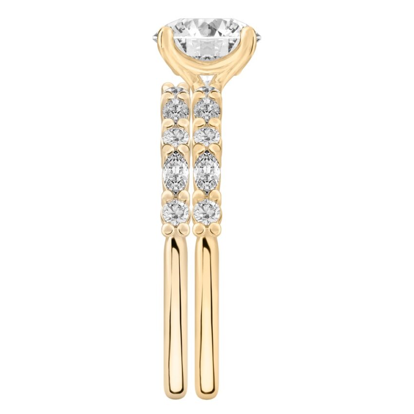 Side view of round cut diamond marquise and round diamond ring set yellow gold