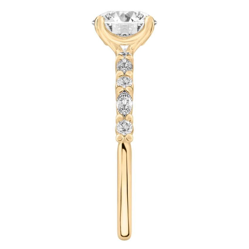 Side view of round cut diamond marquise and round diamond ring yellow gold