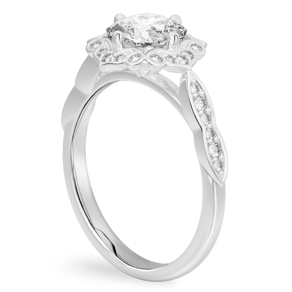 Angle view of cushion cut diamond floral engagement ring in platinum