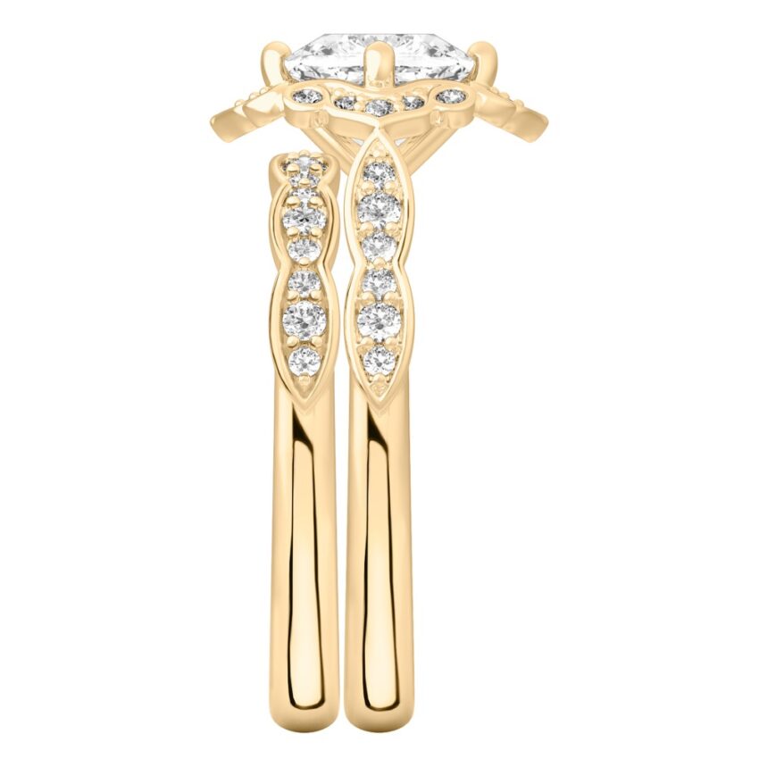 Side view of cushion cut diamond floral engagement ring set yellow gold