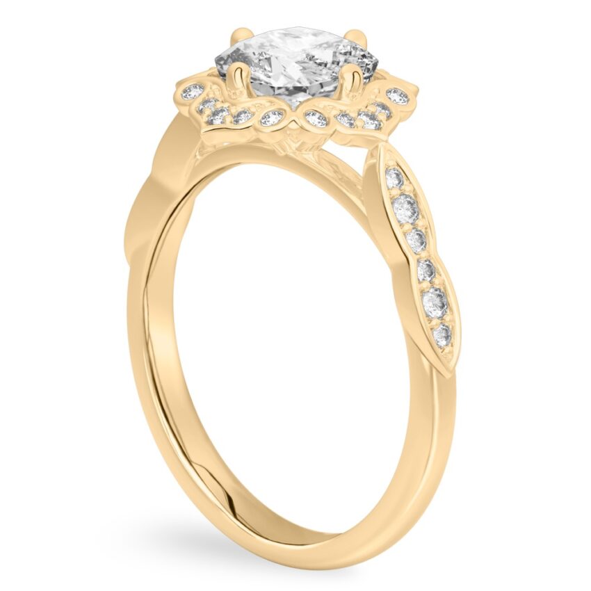 Angle view of cushion cut diamond floral engagement ring in yellow gold