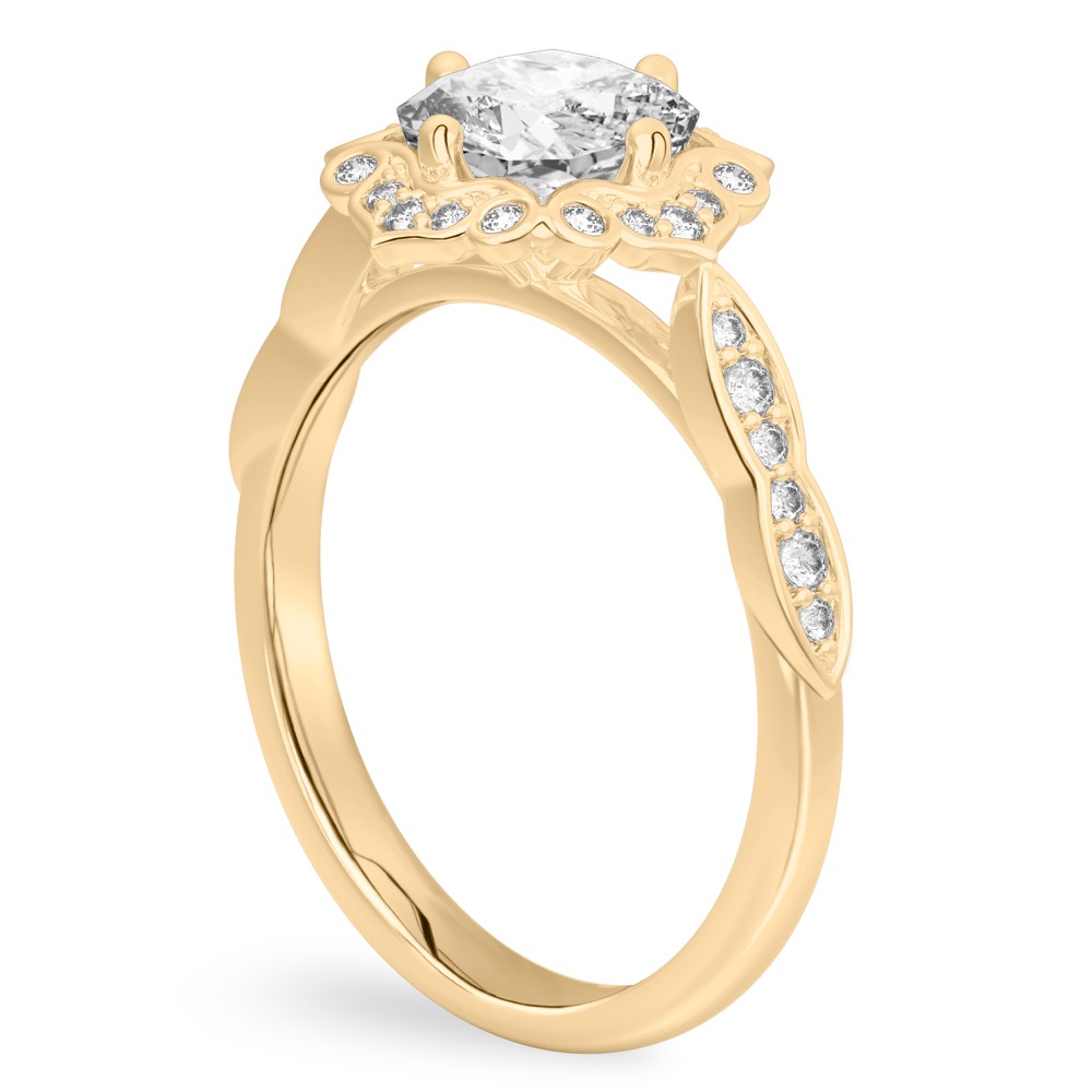 Angle view of cushion cut diamond floral engagement ring in yellow gold