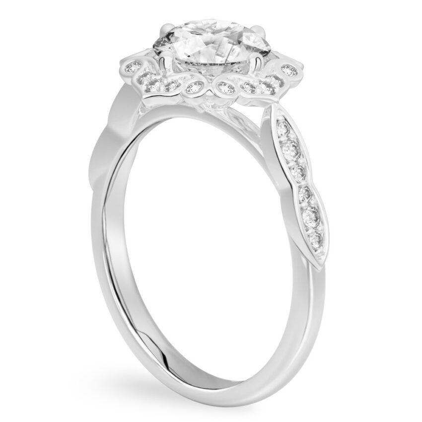 Angle view of round cut diamond floral engagement ring in platinum