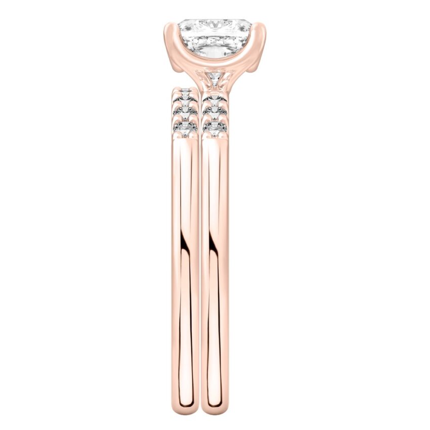 Side view of cushion cut diamond minimalist pave engagement ring set rose gold