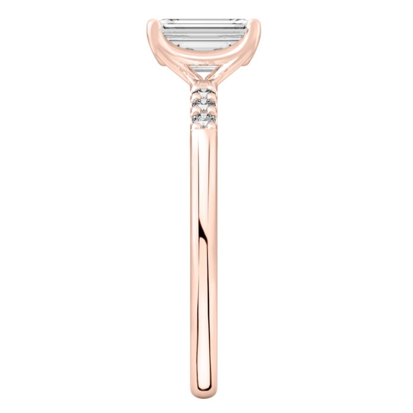 Side view of emerald cut diamond minimalist pave engagement ring in rose gold