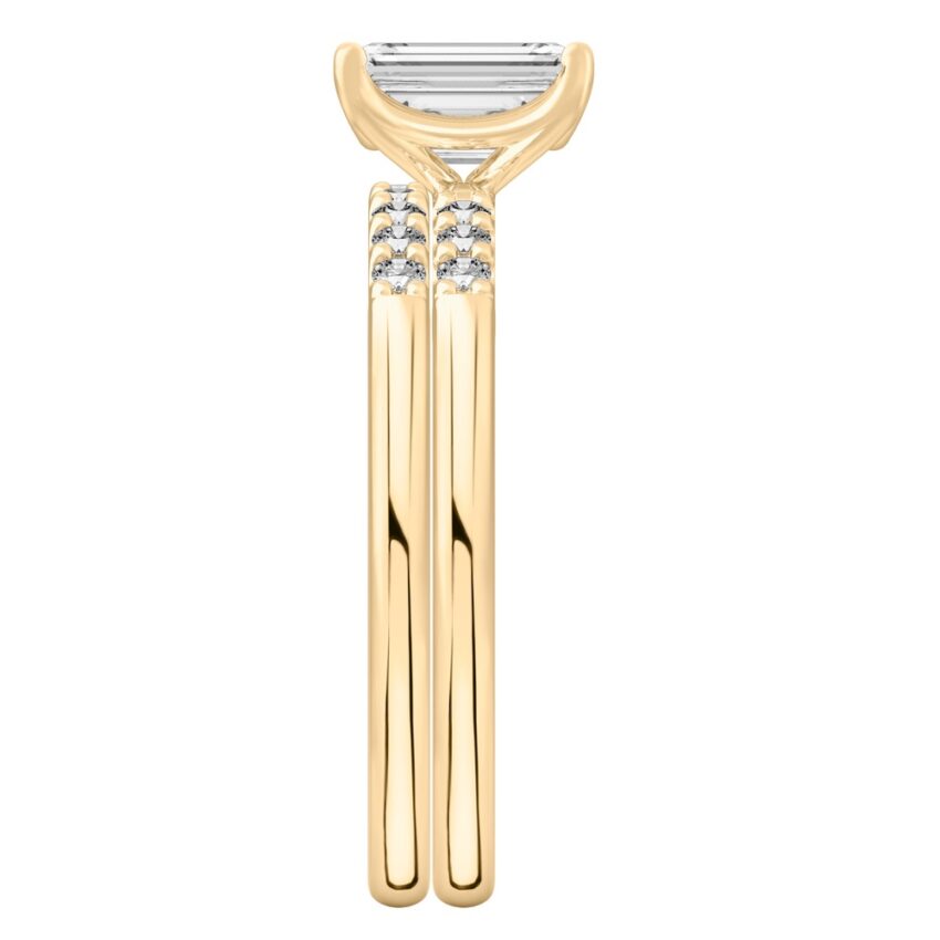 Side view of emerald cut diamond minimalist pave engagement ring set yellow gold