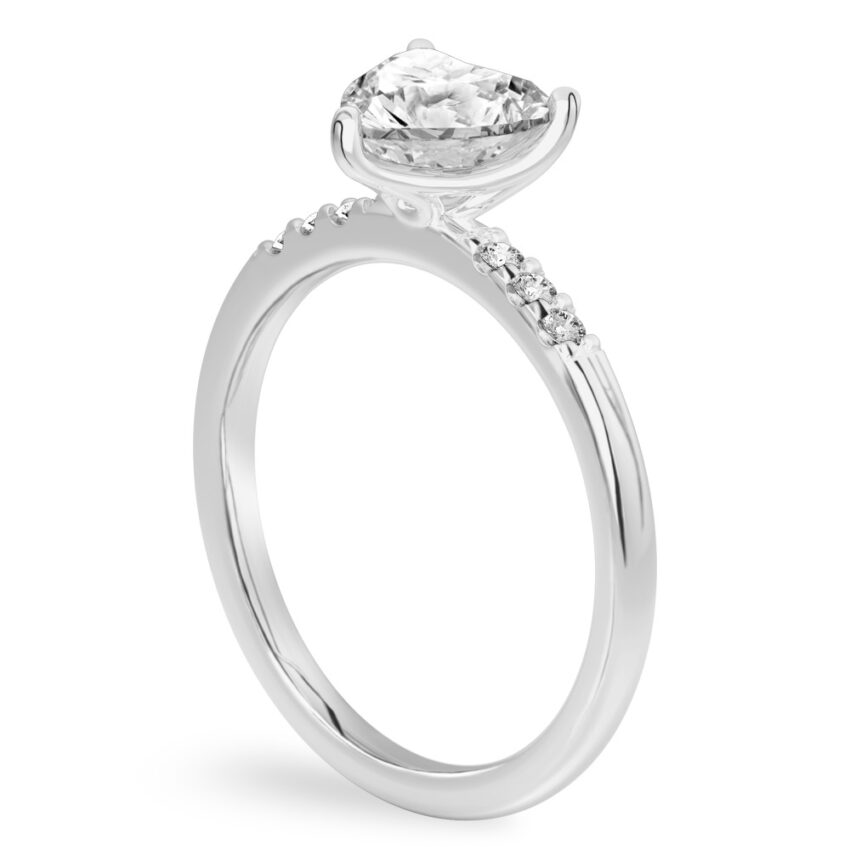 Angle view of heart shape diamond minimalist pave engagement ring in platinum