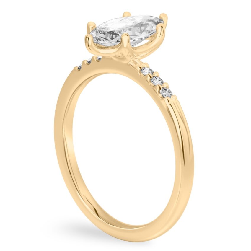 Angle view of marquise cut diamond minimalist pave engagement ring in yellow gold