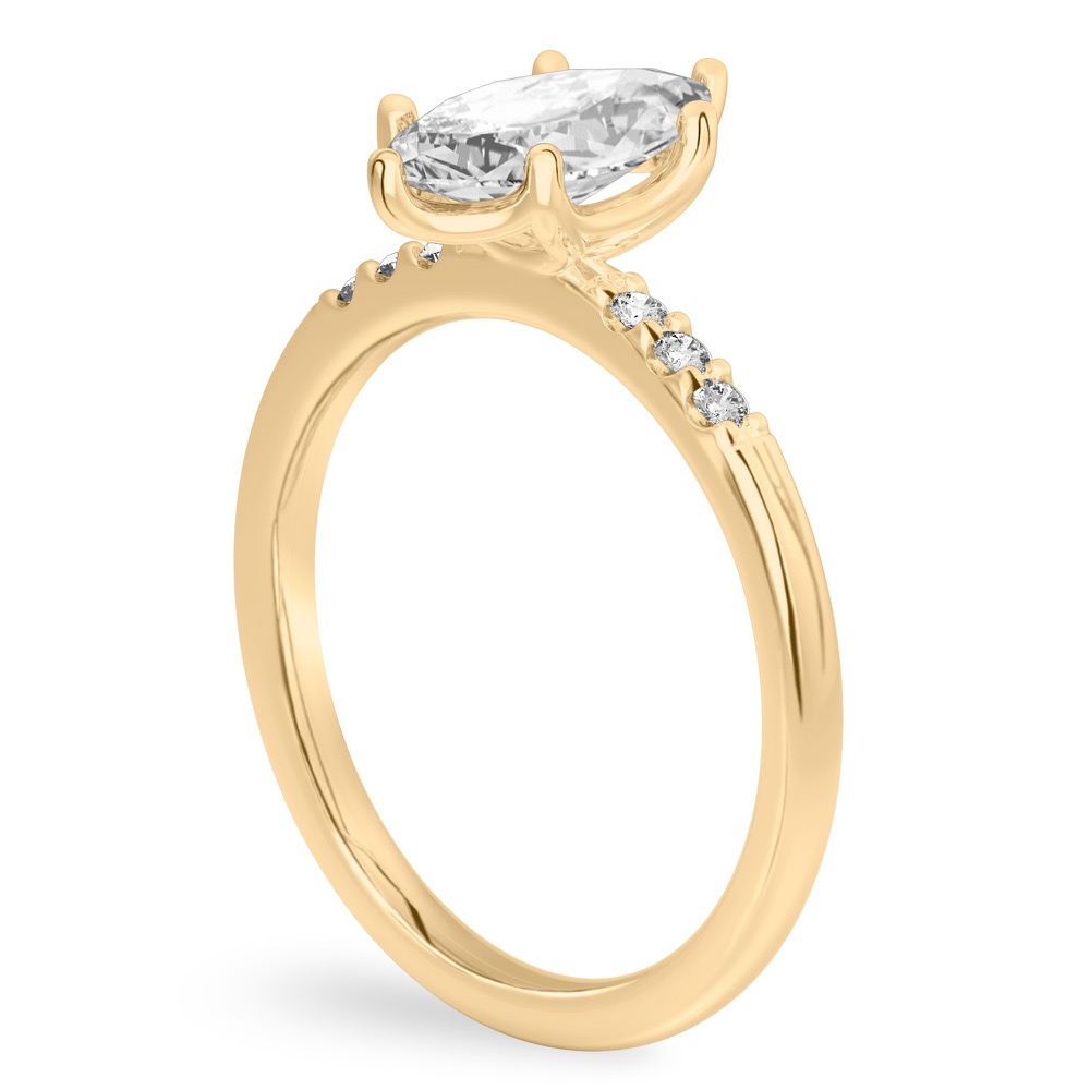 Angle view of marquise cut diamond minimalist pave engagement ring in yellow gold