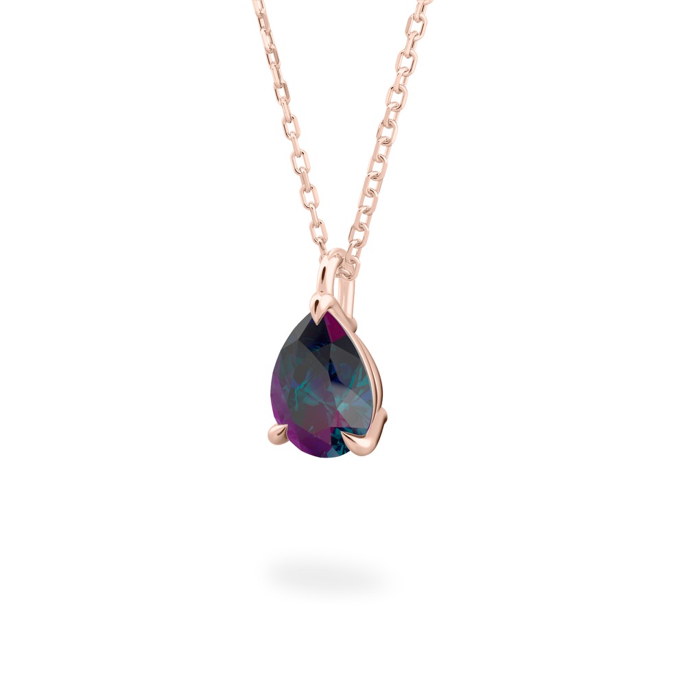 Angle view of pear alexandrite necklace in and earrings rose gold
